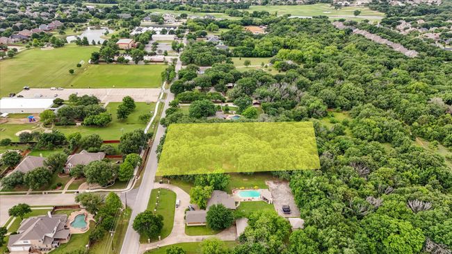 Aerial view of residential area with a nearby body of water and a pool area | Image 6