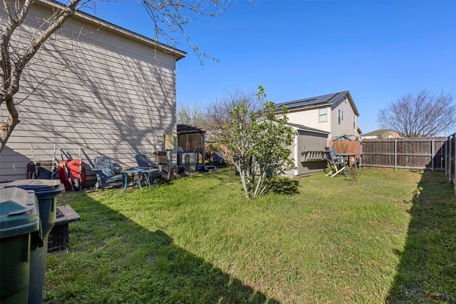 View of yard with a fenced backyard, an outbuilding, and a shed | Image 35