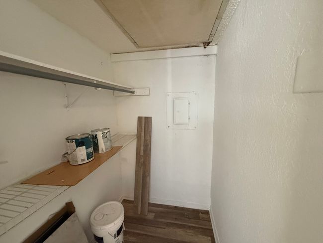 Spacious closet with electric panel and wood finished floors | Image 16
