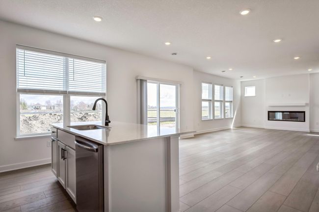 Photo is of the actual home. The kitchen flows into the dining area and great room. | Image 5