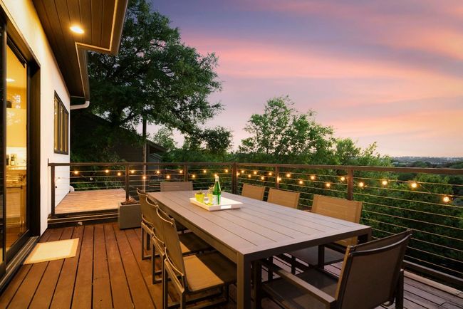 Enjoy this outdoor dining space right off of the kitchen. Custom steel handrails, cedar deck, & recessed lighting. | Image 27