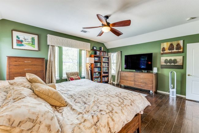 Bedroom featuring lofted ceiling, dark wood finished floors, baseboards, and a ceiling fan | Image 14