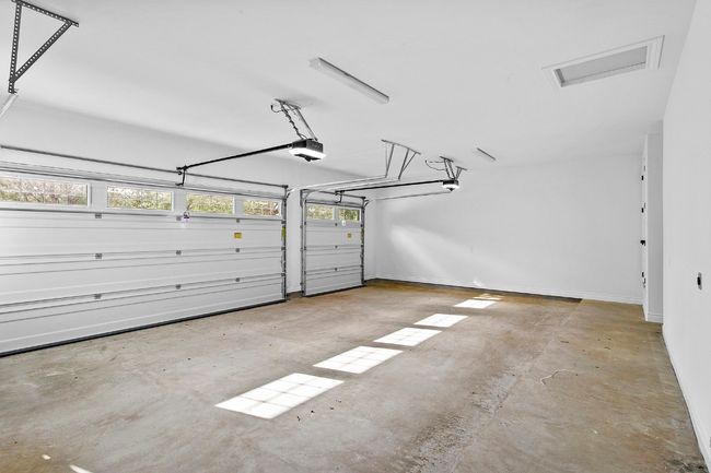 3 car garage featuring baseboards and a garage door opener | Image 28