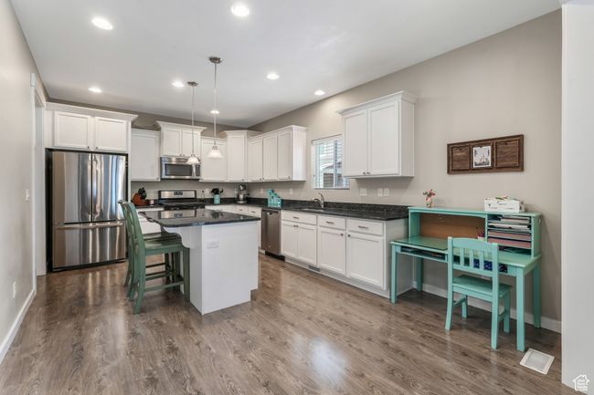 Kitchen with white cabinetry, appliances with stainless steel finishes, and dark wood finished floors | Image 6