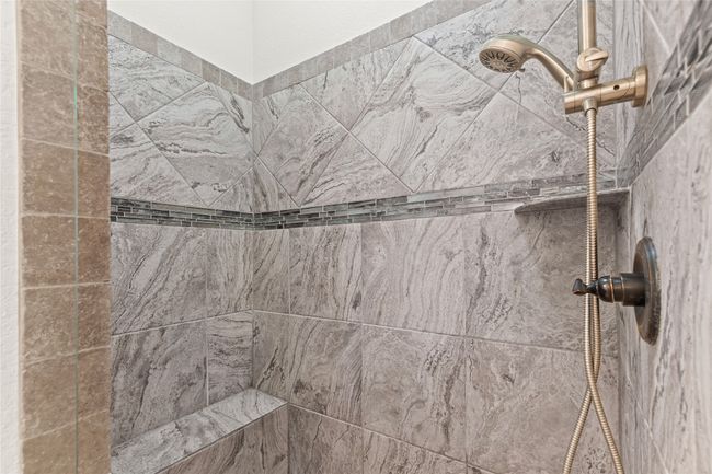Bathroom view of a tile shower | Image 17