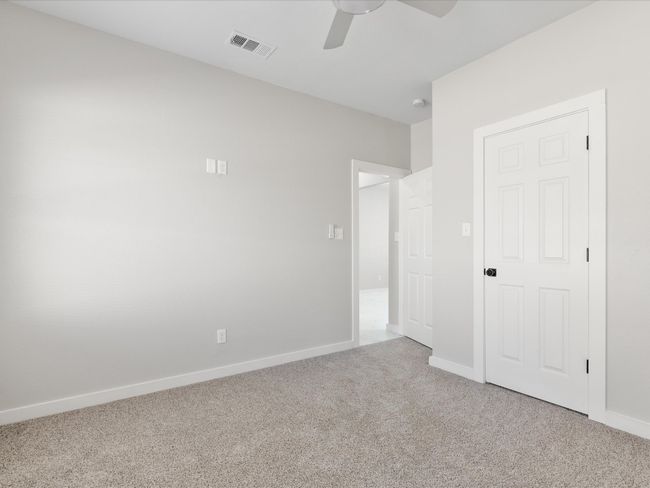 Unfurnished bedroom with a ceiling fan, baseboards, visible vents, and carpet floors | Image 14