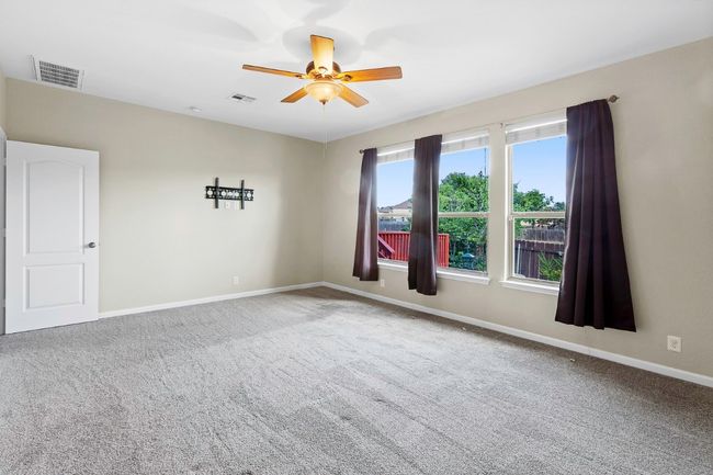 Unfurnished room with carpet floors and a ceiling fan | Image 20