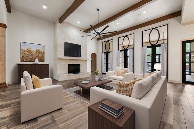 Living area featuring a high end fireplace, ceiling fan, recessed lighting, and beam ceiling | Image 7