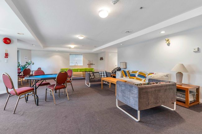 Carpeted living area with a raised ceiling, recessed lighting, and baseboards | Image 28