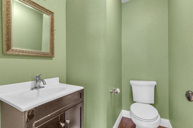 Half bathroom featuring toilet and vanity. | Image 20