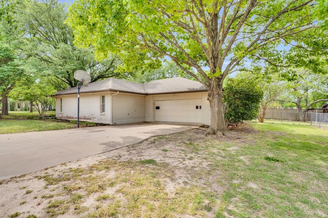Generously sized 2-car garage with workbench and large storage closet. | Image 29