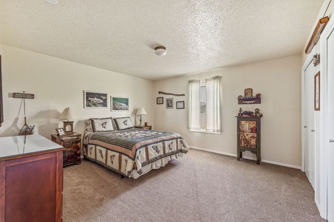 Carpeted bedroom with baseboards and a textured ceiling | Image 19