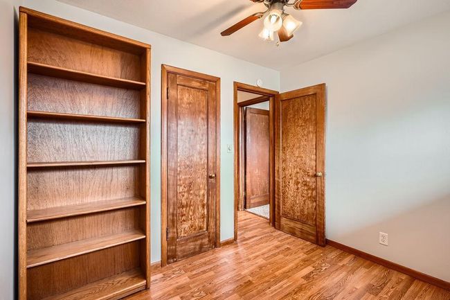Lovely bedroom with book shelf and nice wood doors. Would make a nice craft room, office, or bedroom if needed. | Image 20