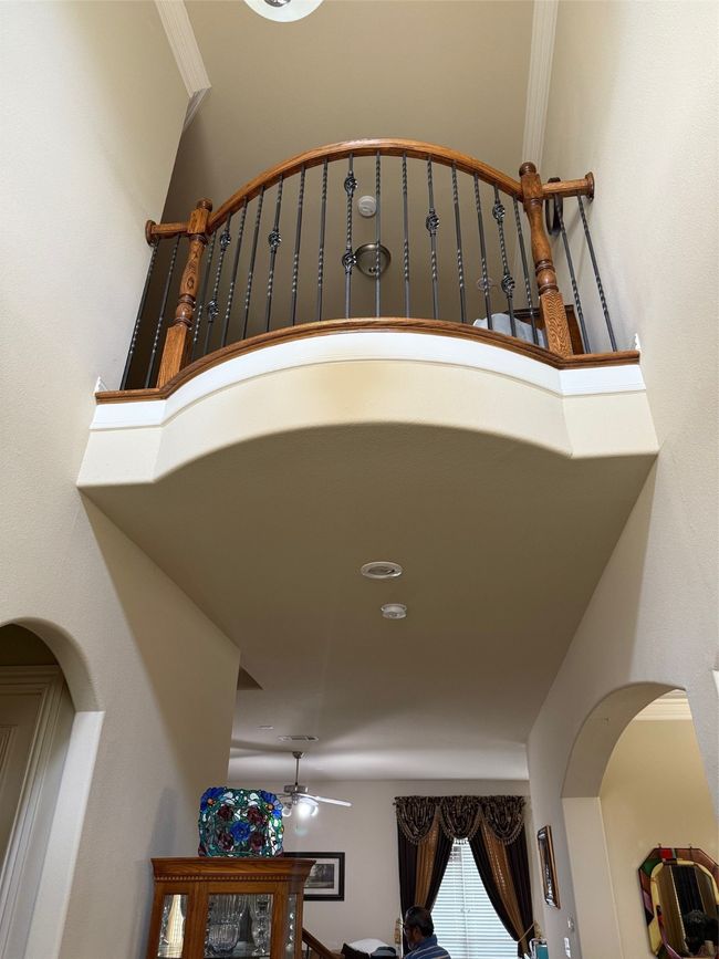 Detailed view of a ceiling fan and arched walkways | Image 25