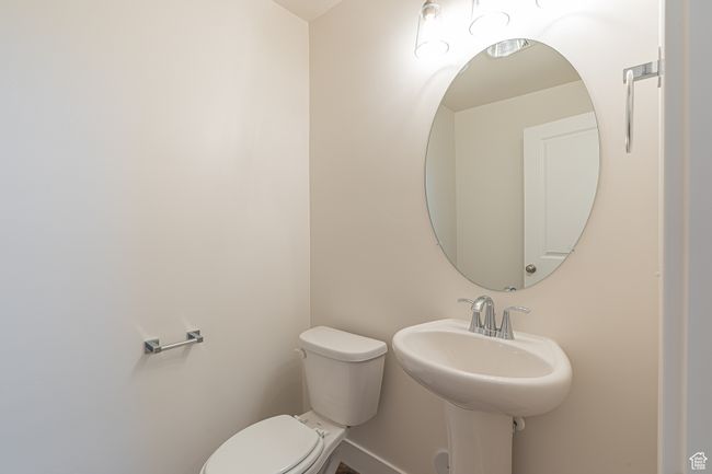 Half bath featuring toilet and baseboards | Image 9