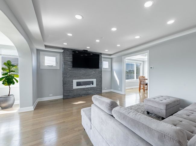 Sun-drenched living room with gleaming hardwood fl | Image 20
