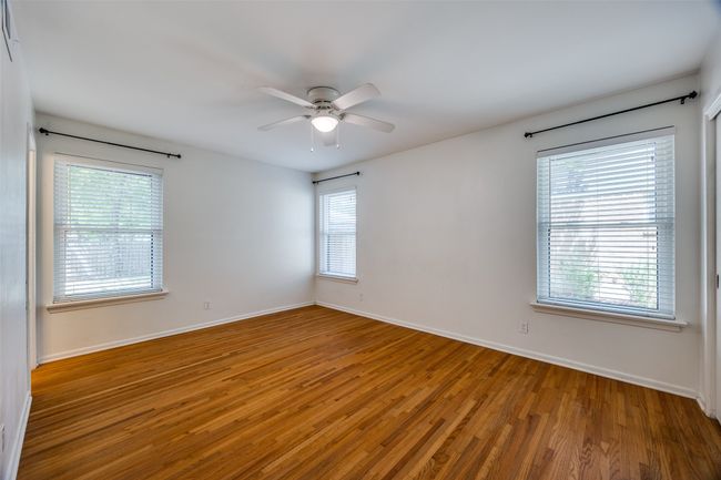 Unfurnished room featuring wood finished floors and a ceiling fan | Image 8