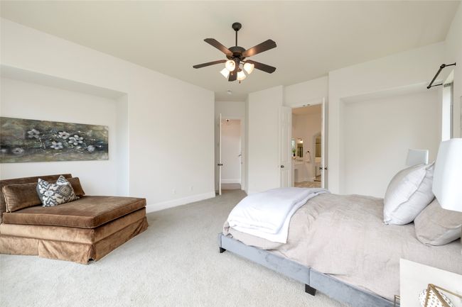 Bedroom featuring light carpet and ceiling fan | Image 17
