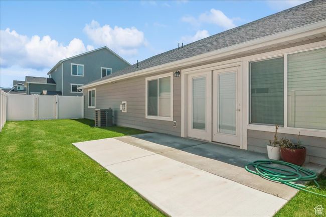 Back of house featuring central AC, a patio area, and roof with shingles | Image 27