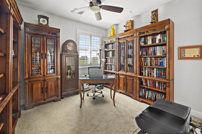 Office area with ceiling fan and light colored carpet | Image 13
