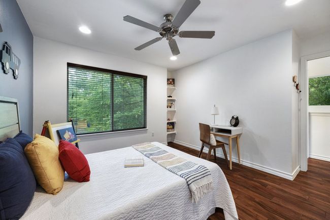 Bedroom featuring wood finished floors, baseboards, recessed lighting, and a ceiling fan | Image 29