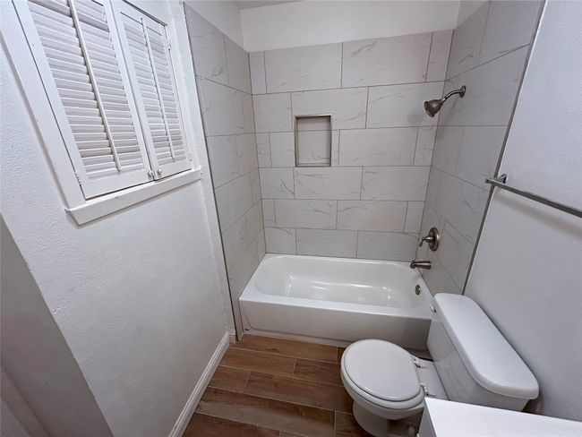 Bathroom featuring toilet, tiled shower / bath, and Luxury Vinyl Plank flooring | Image 27