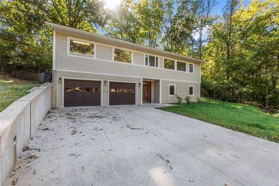 View of front of property with a front yard and a garage | Image 1