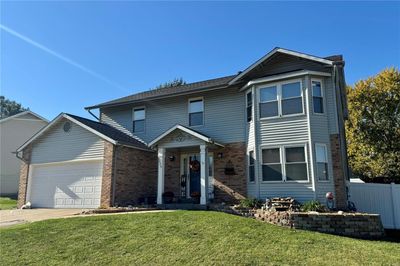 View of property featuring a front yard and a garage | Image 1