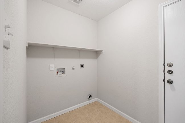Laundry area featuring electric dryer hookup, hookup for a gas dryer, and washer hookup | Image 14
