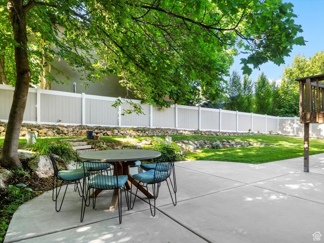 Fenced backyard with outdoor dining area and a patio | Image 39