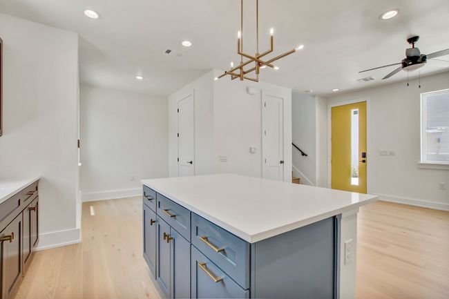 Kitchen with light wood-style floors, recessed lighting, baseboards, a center island, and a ceiling fan | Image 12
