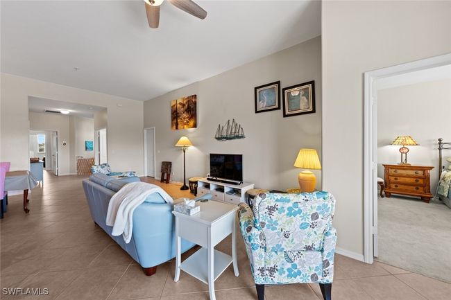 Living area featuring baseboards, a ceiling fan, and light tile patterned floors | Image 16