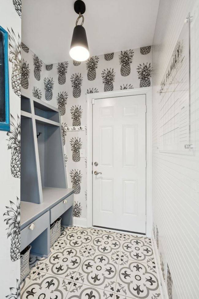 Stylish and cheerful entryway with built-in cubbies and bold wallpaper. Zero step entry from the two car garage. | Image 11