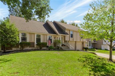 View of front of house with a garage and a front yard | Image 2