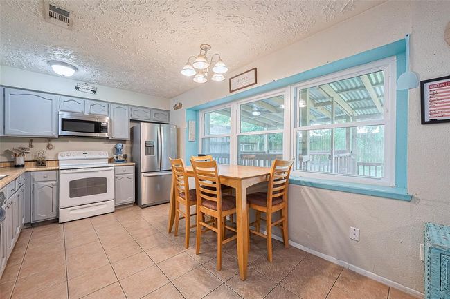 Kitchen/dining combo with lots of natural lighting. | Image 10
