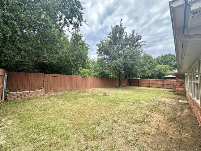 View of fenced backyard | Image 36