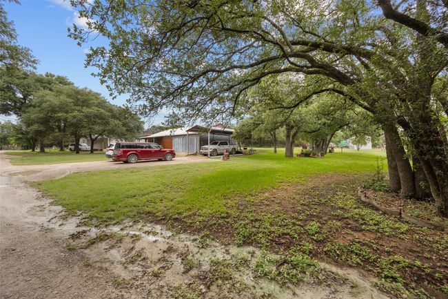 Street view with driveway and St. Augustine grass. | Image 21