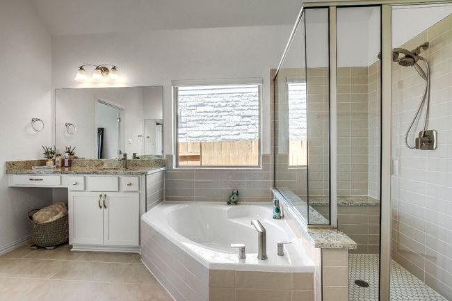 Bathroom featuring a shower stall, a garden tub, double vanity, and tile patterned beautiful floors | Image 21