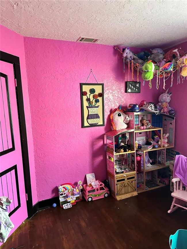 Playroom with a textured wall, a textured ceiling, and wood finished floors | Image 25