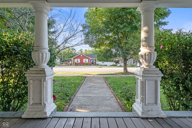 view of green lawn with a porch | Image 6