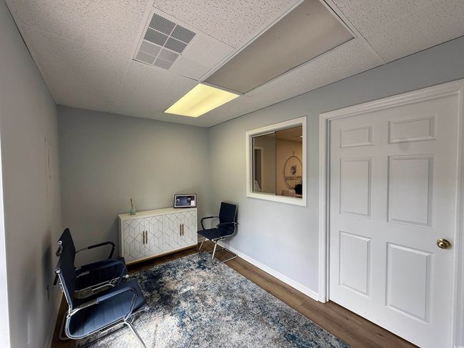 Sitting room featuring wood finished floors and a drop ceiling | Image 4