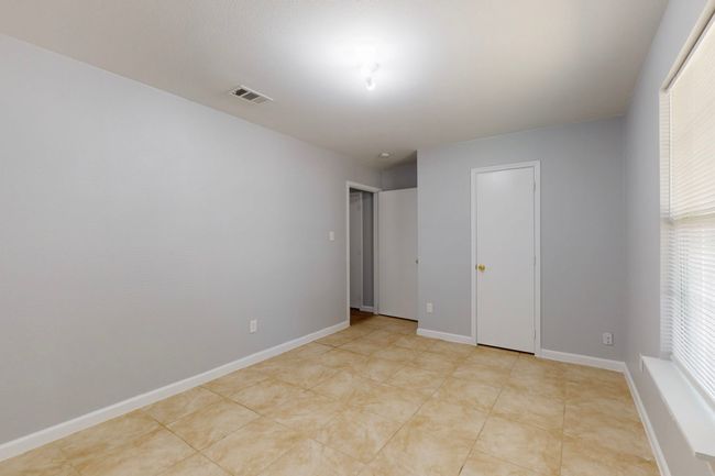 Spare room with baseboards, visible vents, and a healthy amount of sunlight | Image 17