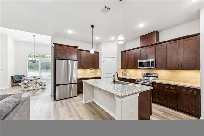 Spacious Kitchen with Granite Countertops and plenty of Cabinets and Counterspace | Image 4