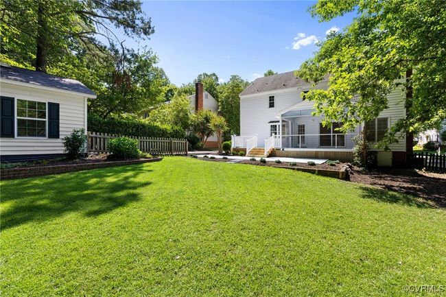 Rear yard. One-car garage on the left, patio, deck and screened porch. | Image 39