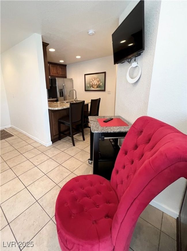 Living room with light tile patterned flooring, baseboards, indoor wet bar, and recessed lighting | Image 4