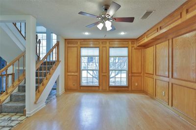 Living room with a ceiling fan, and light wood-type flooring | Image 3