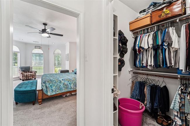 Primary bedroom features his-and-her walk-in closets. | Image 19