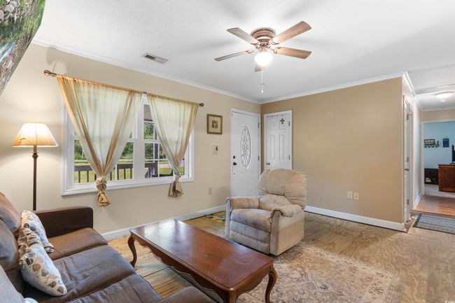 Dining room featuring crown molding and light tile patterned floors | Image 11