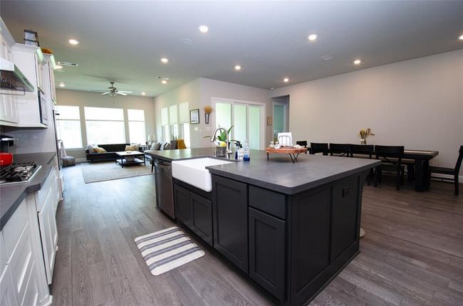 The open-concept kitchen and dining area offers plenty of natural light from the sliding glass doors creating great atmosphere for entertaining. | Image 12