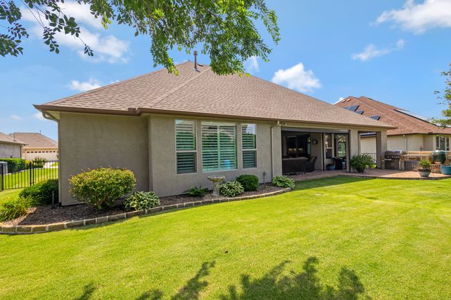 Back of property with a patio, stucco siding, roof with shingles, and area for grilling | Image 31